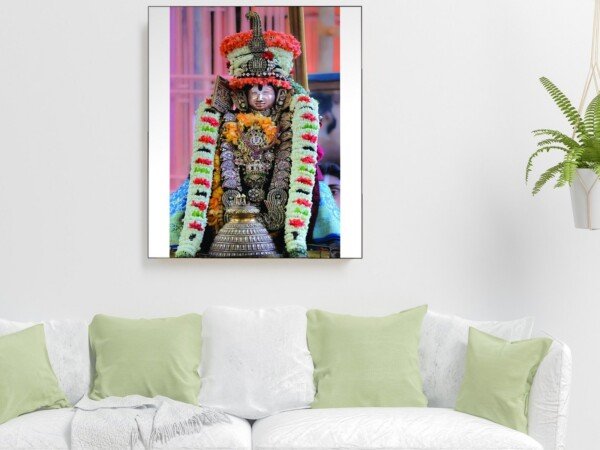 utsava deity in garlands canvas wall art shown framed on a wall