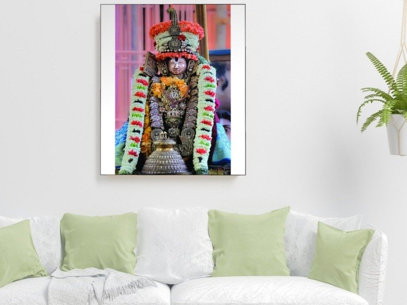 utsava deity in garlands canvas wall art shown framed on a wall